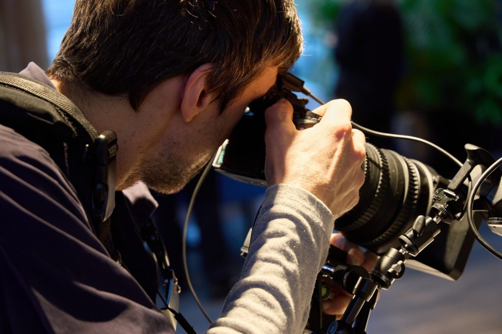 Professional Photographer Skillfully Capturing Precious Moments with a DSLR Camera in Action